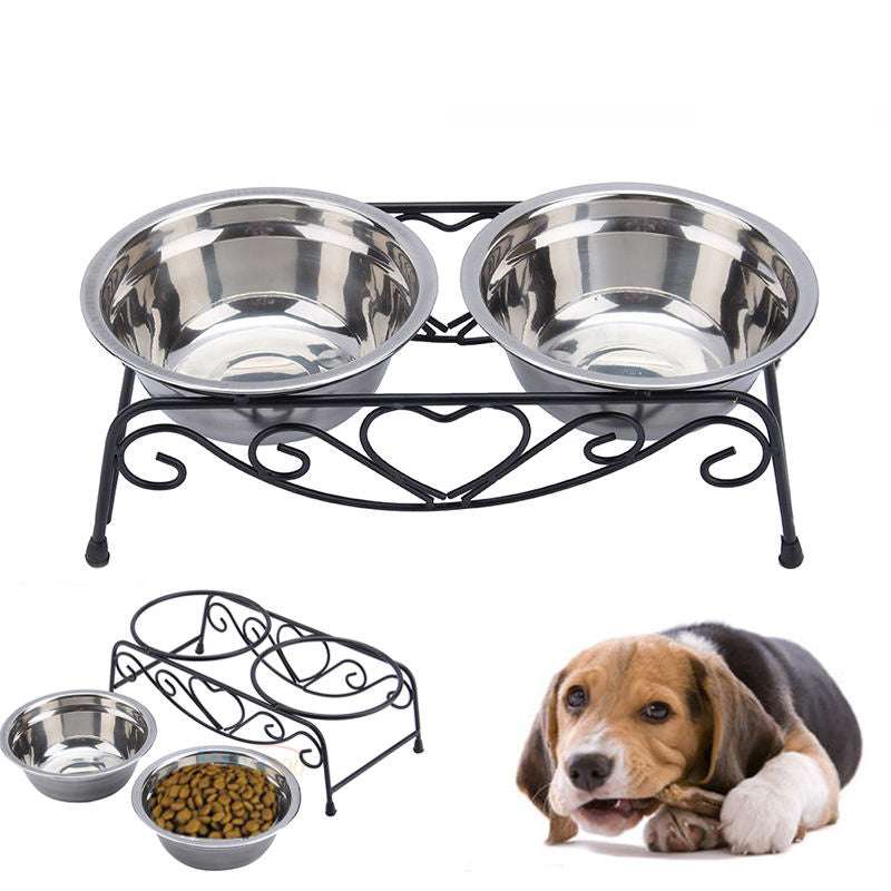 Double stainless steel pet bowl set with decorative black metal stand and a dog lying beside it