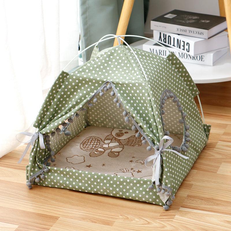 Green polka dot enclosed tent bed for pets with soft cushioned interior and pom-pom trim, ideal for cats and small dogs
